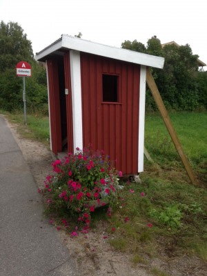 Några starka bybor tog saken i egna händer och lyfte busskuren på plats igen.
